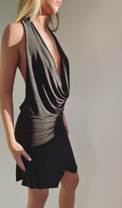 Elegant sort backless kjole i strækbar jersey materiale med åben ryg og draperet halsudskæring – perfekt til festlige anledninger og tidløse looks